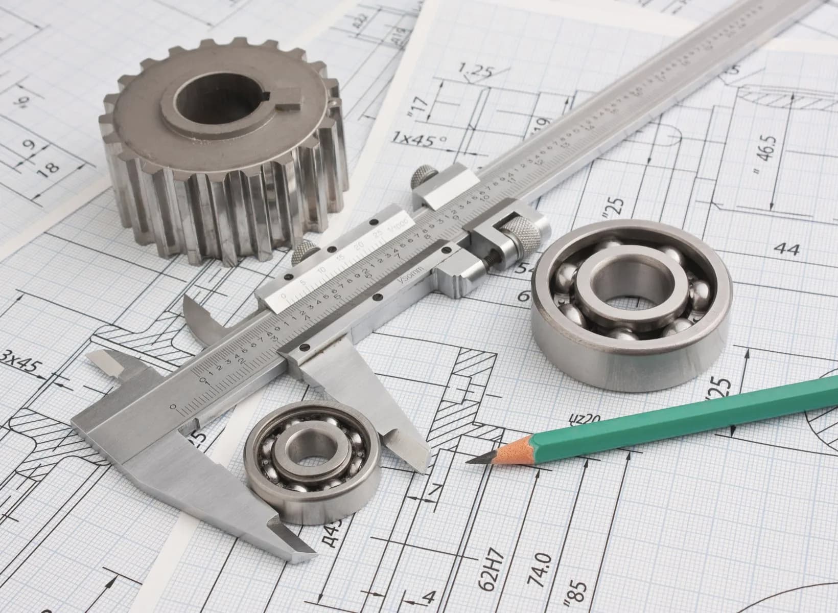 Ball bearings being measured against technical drawings.