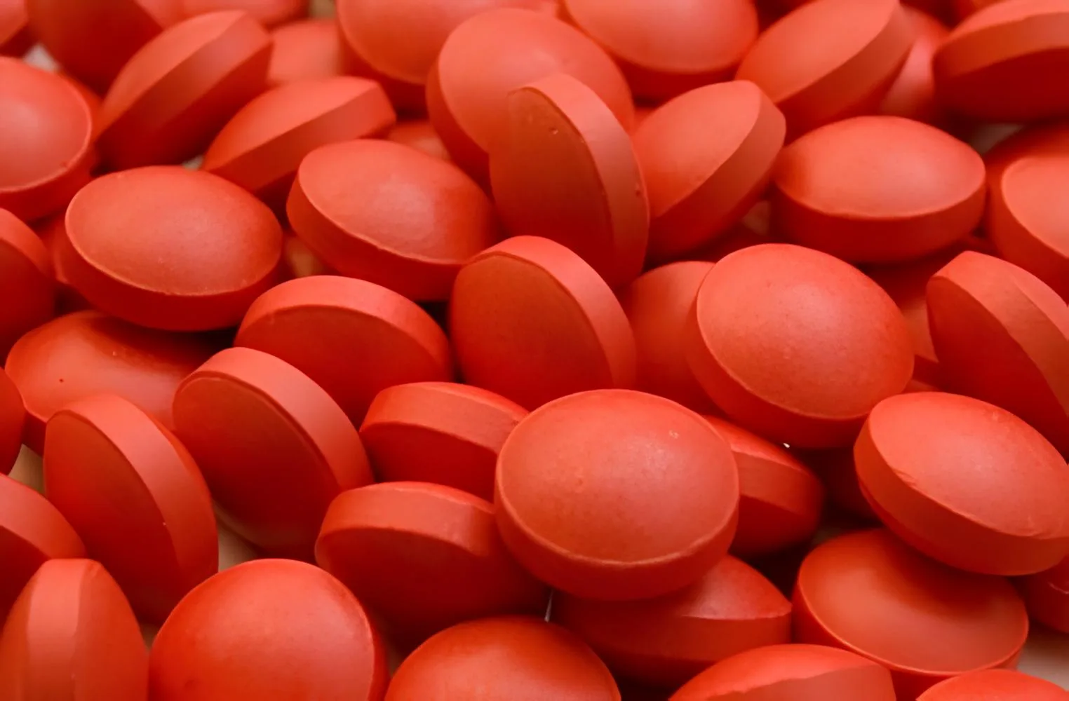 A close up shot of reddish orange tablets.