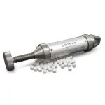 Stokes Tablet Hardness Tester resting atop of white tablets.