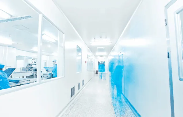 A blurry image of a clean pharmaceutical manufacturing facility.